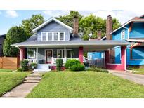 Charming two-story home with a covered porch and a well-manicured front yard at 726 E 33Rd St, Indianapolis, IN 46205