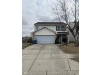 Charming two-story home with a two car garage and a well-manicured front yard at 7659 Misty Meadow Dr, Indianapolis, IN 46217