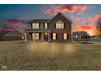 Stunning two-story brick home with a welcoming front porch and beautiful sunset view at 8218 Elsen Ridge, Avon, IN 46123