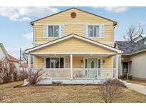 Charming yellow two-story home with a welcoming front porch and white trim at 854 W Roache St, Indianapolis, IN 46208