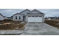 New construction featuring stone accents, gray siding, and an attached two-car garage at 13862 N Americus Way, Camby, IN 46113