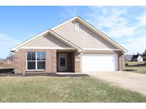 Charming single-story brick home featuring an attached two-car garage and manicured front lawn at 1393 N Salem Ct, Greenfield, IN 46140