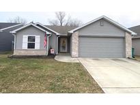 Charming ranch-style home with a gray exterior, brick accents, and well-maintained landscaping at 1629 Jaques Dr, Lebanon, IN 46052