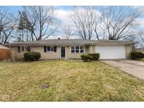 Charming single-story home with a classic brick facade and attached garage, nestled on a well-maintained lot with mature trees at 2534 Morning Star Dr, Indianapolis, IN 46229