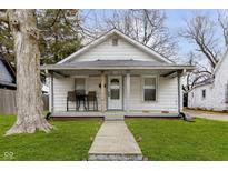 Charming home featuring a welcoming front porch and a well-maintained lawn at 3000 Pearl St, Anderson, IN 46016