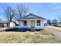 Charming single-story home with a covered front porch, white siding, and well-maintained landscaping at 613 S Mickley Ave, Indianapolis, IN 46241
