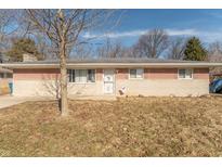 Charming single-story brick home with a well-maintained lawn and a cozy front entrance at 6404 W Ray St, Indianapolis, IN 46241