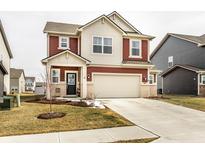 Charming two-story home with a two-car garage and neatly maintained front yard, offering suburban appeal at 717 Oxford Ln, Danville, IN 46122
