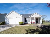 Charming single-story home features white siding, an attached garage, and a well-maintained lawn at 7576 Hollow Reed Ct, Noblesville, IN 46062