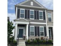 Charming two-story townhome featuring a dark-blue front door, large windows, black shutters, and a well-maintained lawn at 848 Kinzer Ave, Carmel, IN 46032
