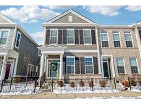 Charming two-story townhome with gray siding, black shutters, and a welcoming front entrance with black steel fencing at 848 Kinzer Ave, Carmel, IN 46032