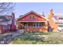 Charming brick home with a well-maintained lawn and inviting front porch at 916 N Audubon Rd, Indianapolis, IN 46219