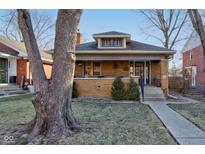 Charming brick home featuring a classic craftsman style and a welcoming front porch at 929 N Audubon Rd, Indianapolis, IN 46219
