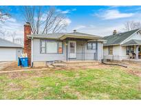 Charming home featuring a quaint front porch and a well-maintained lawn at 1523 S Goodlet Ave, Indianapolis, IN 46241