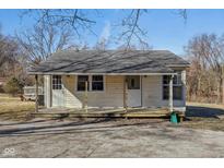 Quaint cottage-style home featuring a covered front porch and neutral siding at 27 State Road 42 W, Mooresville, IN 46158