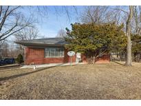 Charming brick ranch-style house with mature landscaping and a DirectTV satellite dish in the front yard at 8350 E Cr 200 S, Zionsville, IN 46077