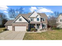 Charming two-story brick home with an attached two-car garage and inviting front porch at 1062 Scarlet Quarry Cir, Avon, IN 46123
