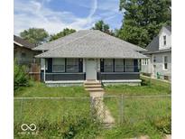 Charming single-story home featuring gray siding, a welcoming front door, and a grassy front yard at 1916 Koehne St, Indianapolis, IN 46202