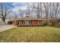 Charming one-story brick home featuring a well-manicured lawn and classic design elements at 208 Northshore Blvd, Anderson, IN 46011