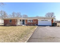 Charming brick ranch-style home with well-maintained lawn and attached two-car garage at 2351 N Raceway Rd, Indianapolis, IN 46234