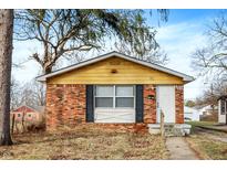 Charming single-story brick home with a well-maintained front yard and inviting entrance at 3026 Stuart St, Indianapolis, IN 46218