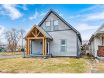 Attractive two-story home showcasing a welcoming covered porch and a well-kept yard at 602 E Beecher St, Indianapolis, IN 46203