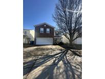 Charming two-story home with brick and siding, featuring a two-car garage and a well-maintained front yard at 6817 Everbloom Ln, Indianapolis, IN 46217