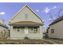 Charming two-story home with a covered front porch and classic architectural details under a partly cloudy sky at 1107 Kappes St, Indianapolis, IN 46221
