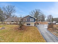 Charming two-story home with stone accents, blue siding, and a long driveway at 12166 Bray Rd, Mooresville, IN 46158