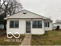 Charming single-story home features a tidy front yard and white siding at 1220 E Second St, Greenfield, IN 46140