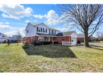 Beautiful two-story home boasts a well-maintained lawn and attached two-car garage at 12225 Sunrise Dr, Indianapolis, IN 46229