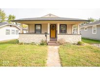 Charming single story home with a covered front porch and a stone facade in a desirable location at 1645 N Somerset Ave, Indianapolis, IN 46222