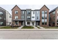 Modern townhomes with mixed material facades, including brick, siding, and metal accents at 1819 N New Jersey St, Indianapolis, IN 46202