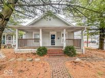 Charming bungalow with a covered front porch and brick walkway, creating a welcoming entrance at 1824 Southeastern Ave, Indianapolis, IN 46201