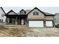 Charming two-story home featuring a brick-accented porch and a two-car garage at 19868 Chatham Shore Ln, Westfield, IN 46074
