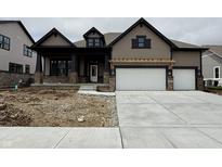 Two-story home featuring a two-car garage, covered porch, brick accents, and neutral colored siding at 19868 Chatham Shore Ln, Westfield, IN 46074