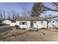 Charming single story home featuring white siding and a brown front door at 4952 Mathews Ave, Indianapolis, IN 46227