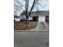 Charming home featuring a brick facade, attached garage and a well-maintained lawn at 5732 Eden Village Way, Indianapolis, IN 46254