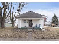 Charming single-story home featuring a cozy front porch with seating and an American flag at 603 W Pearl St, Lebanon, IN 46052