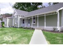 Charming single-story home showcasing a well-manicured lawn and inviting front porch at 621 W 10Th St, Indianapolis, IN 46202
