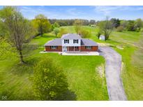 Aerial view of the home, showcasing the expansive lawn and the surrounding landscape at 6629 N 600 W, Fairland, IN 46126