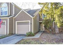Charming two-story townhome with brown shingle siding and an attached one-car garage at 7459 Quincy Ct, Indianapolis, IN 46254