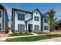 Charming two-story home with white siding, gray trim, a well-manicured lawn and attractive curb appeal at 780 James William Ln, Westfield, IN 46074