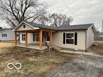 Inviting single-story home with a covered porch and neutral siding at 1007 N 10Th St, Elwood, IN 46036