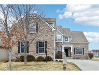 Charming two-story brick home with well-maintained lawn and inviting curb appeal at 14402 Wolverton Way, Fishers, IN 46037