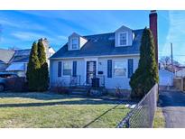 Charming two-story home with blue shutters, a well-kept lawn, and a brick chimney at 3533 N Grant Ave, Indianapolis, IN 46218