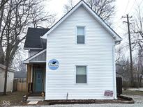 Charming home featuring white siding, a cozy front porch, and well-maintained landscaping at 498 Johnson Ave, Franklin, IN 46131