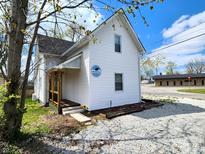 Charming two-story home featuring white siding, an inviting entrance and well-kept landscaping at 498 Johnson Ave, Franklin, IN 46131