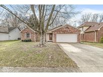 Charming single-story brick home with a two-car garage and mature landscaping at 541 Louise Dr, Indianapolis, IN 46217