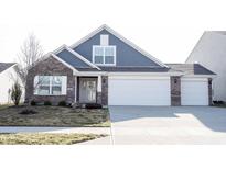 Charming single-Gathering home with a well-maintained lawn and a two-car garage at 8709 Stoddard Ln, Indianapolis, IN 46217